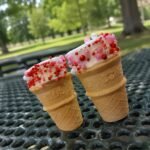 A 3 pack of miniature 2 bite ice cream cones filled with marshmallow and a hint of chocolate then topped with sprinkles.